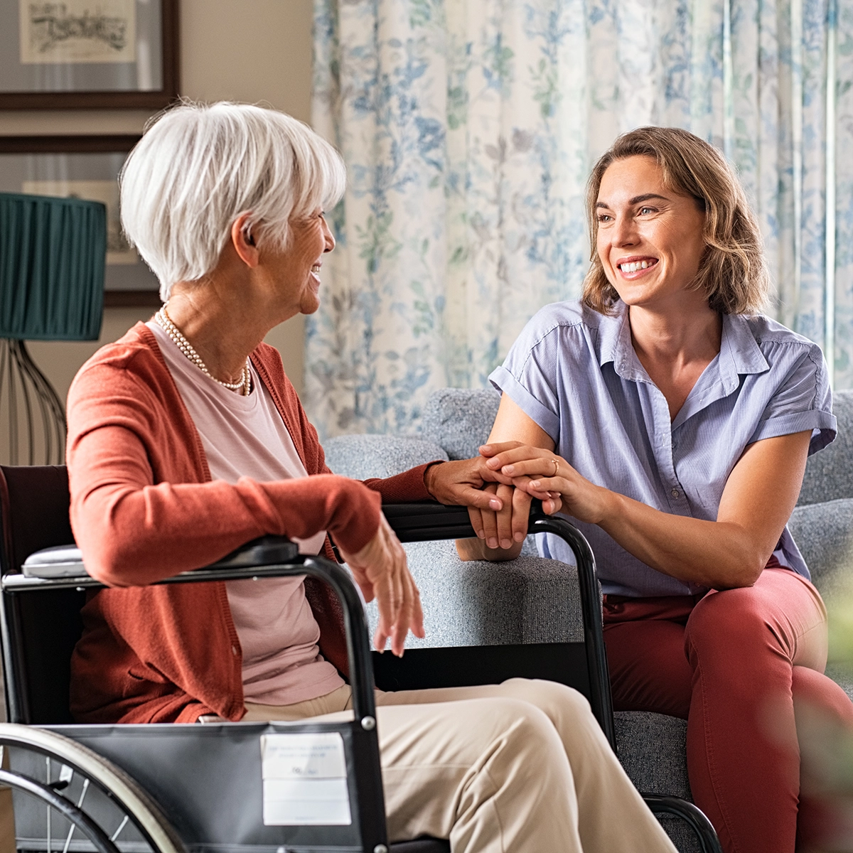 caring woman with a woman in the wheelchair